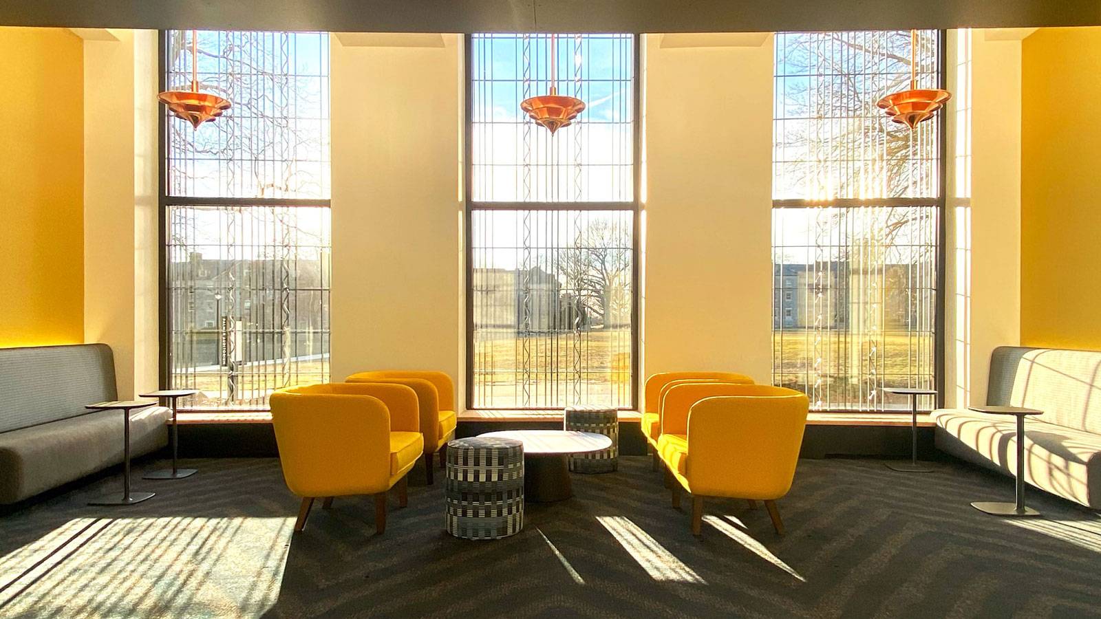 Two yellow chairs in the Athey Center looking out the window