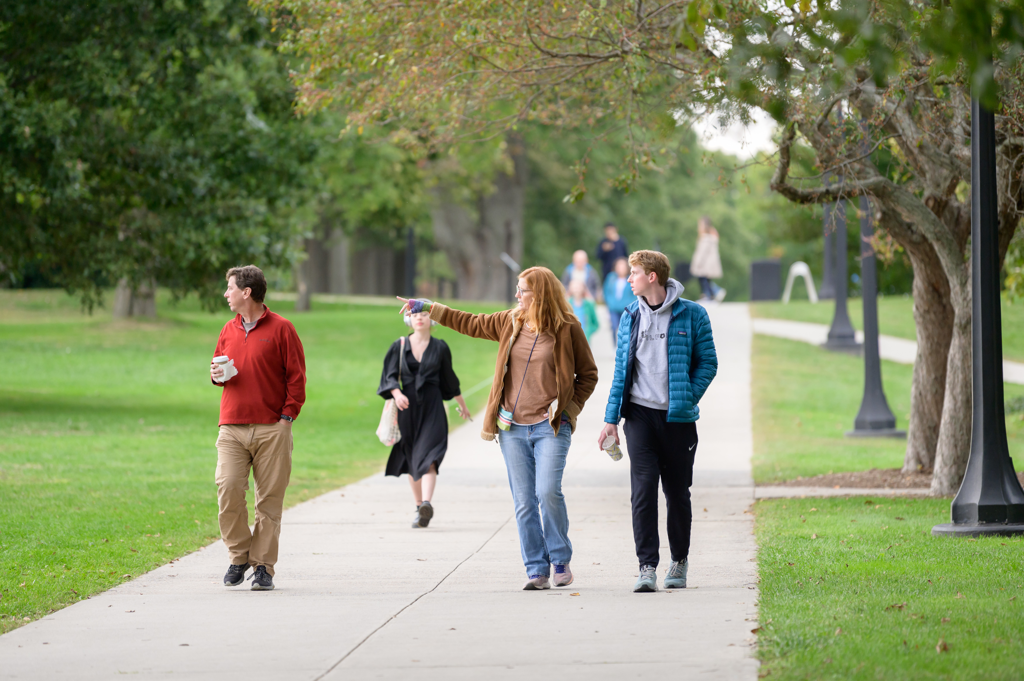 Families walking past the green