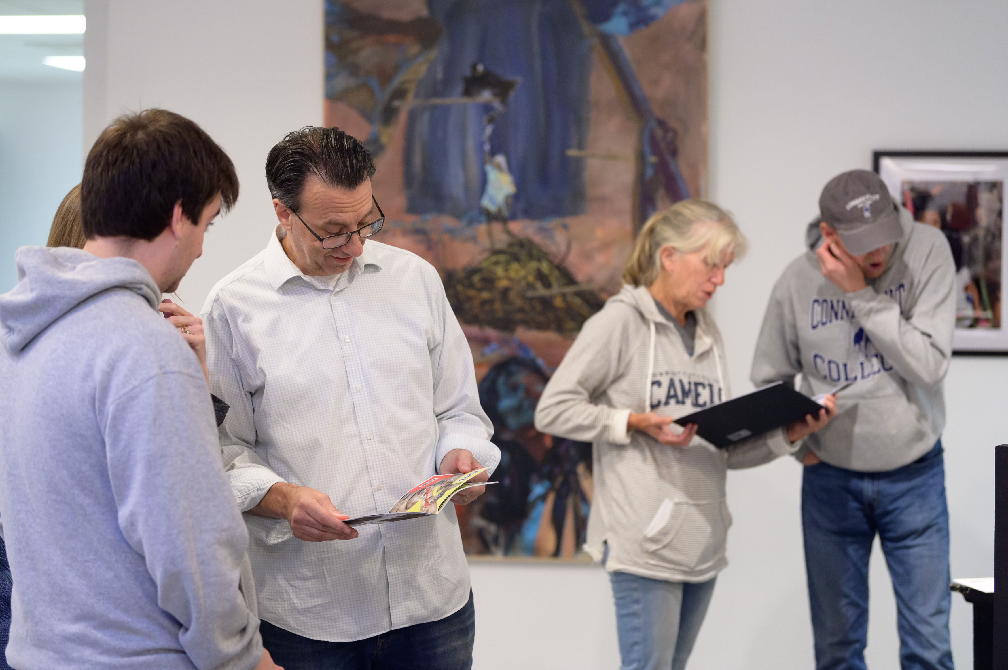 Parents and students looking over program books