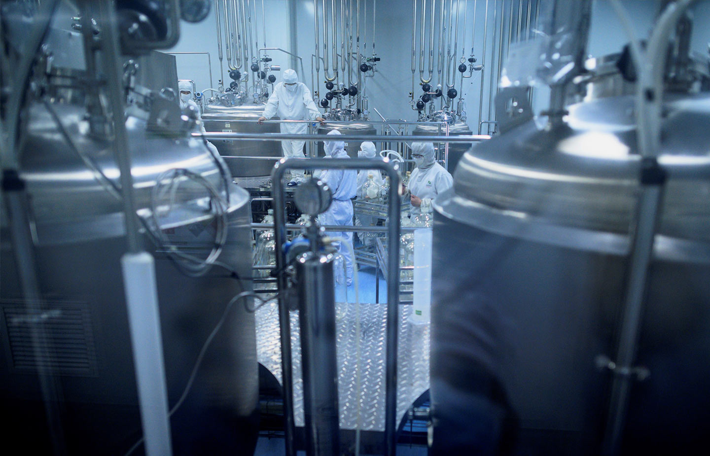 Image of scientist working in a lab with hazmat suits on