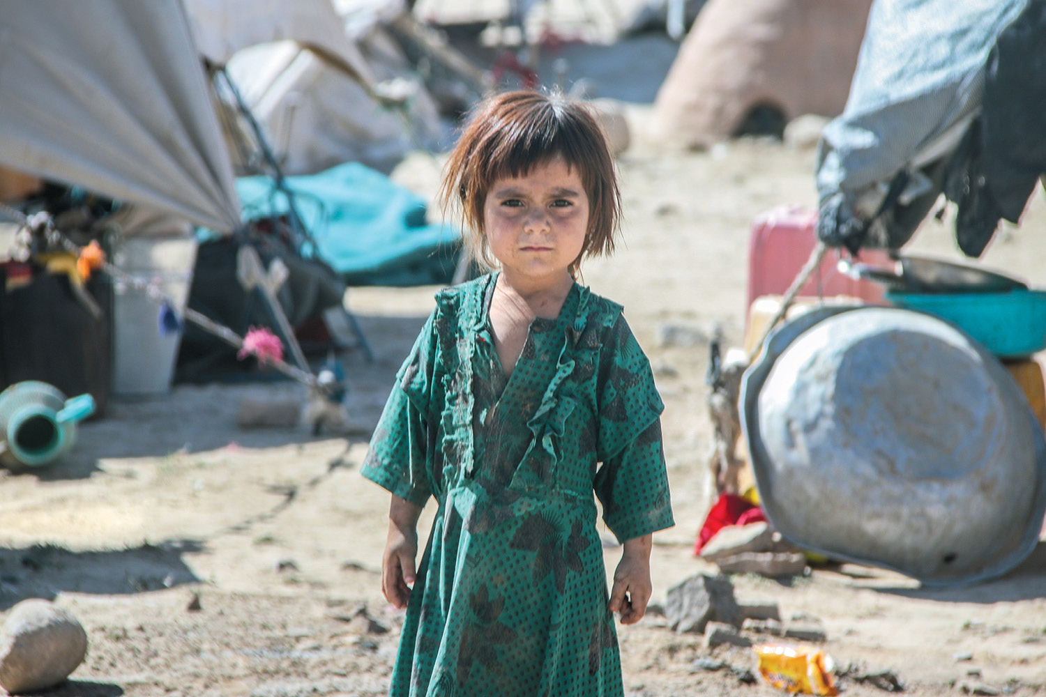 Child on desolate landscape in Afghanistan