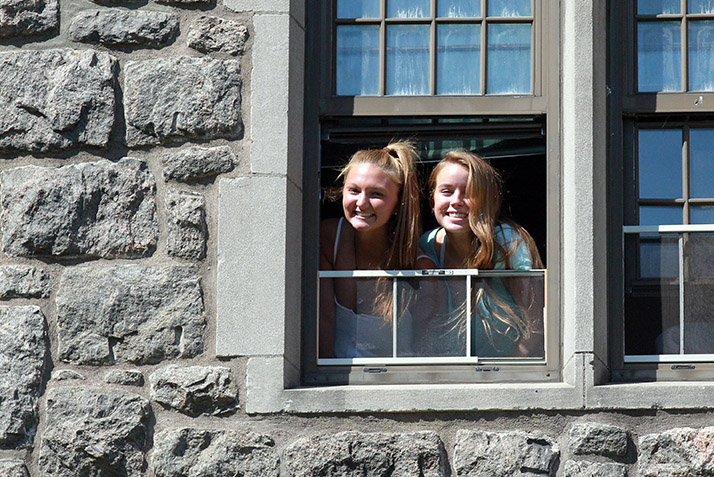 New roommates smile from the window