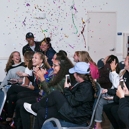 Members of the women's soccer team celebrate as they learn the team has earned a bid to the NCAA tournament. 