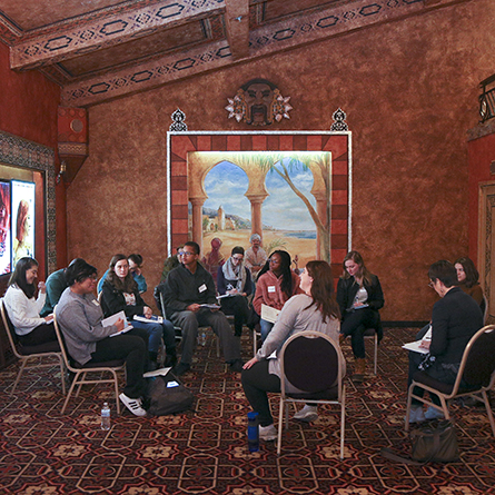 A small group of students sits in a circle in the foyer of the Garde Arts Center