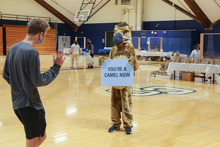 The Camel mascot greets new students at the check in desk