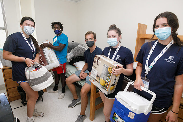 Student leaders help two new students move into their rooms.