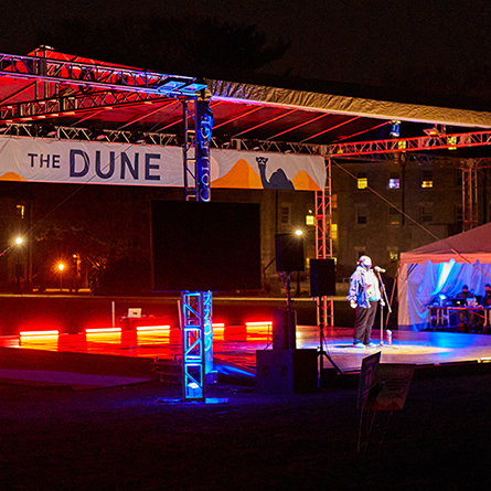 A student sings during the Eclipse show on The Dune. 