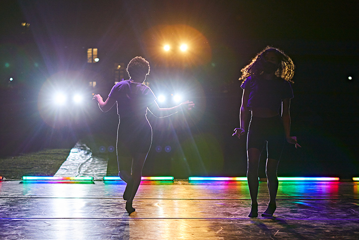 Bright lights shine on student performers. 