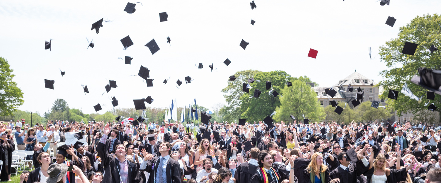 Members of the class of 2022 toss their caps.