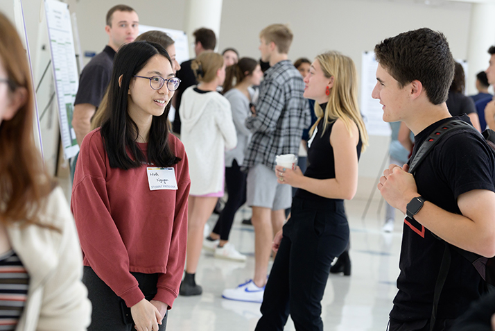 A student presents a poster at the ACS poster session.