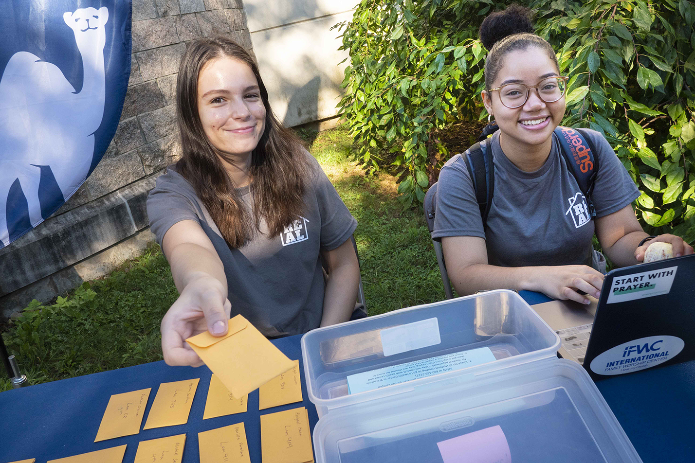 Student leaders give the newest students their IDs.