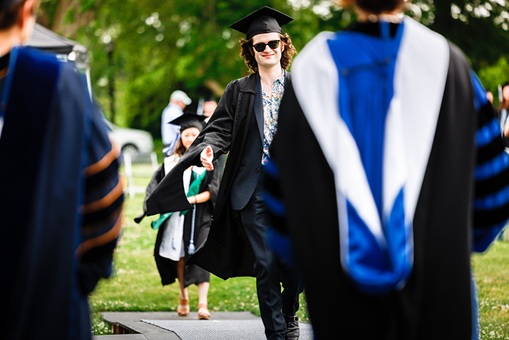 A graduate crosses the stage