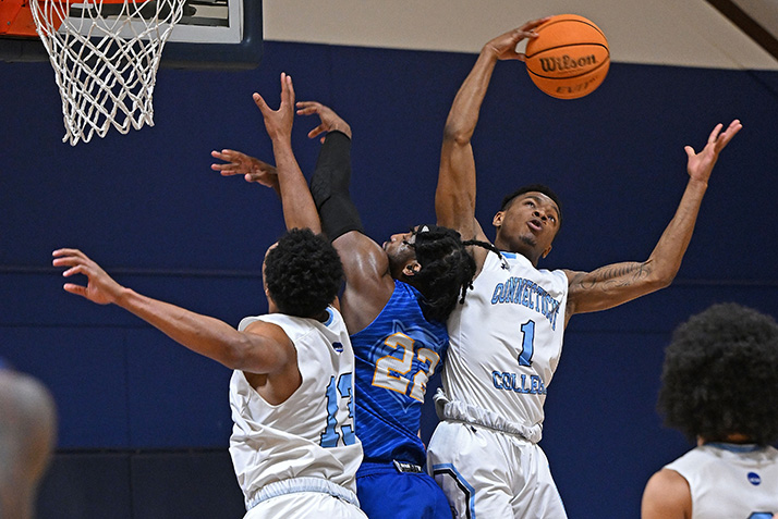 Two Conn students go up for a ball.