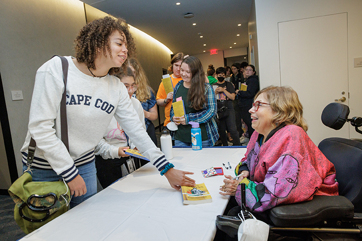 Activist and author Judith Heumann signs books after her One Book One Region event.