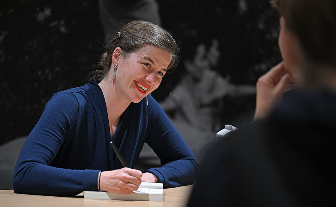 Author Elizabeth Rush signs copies of her book.