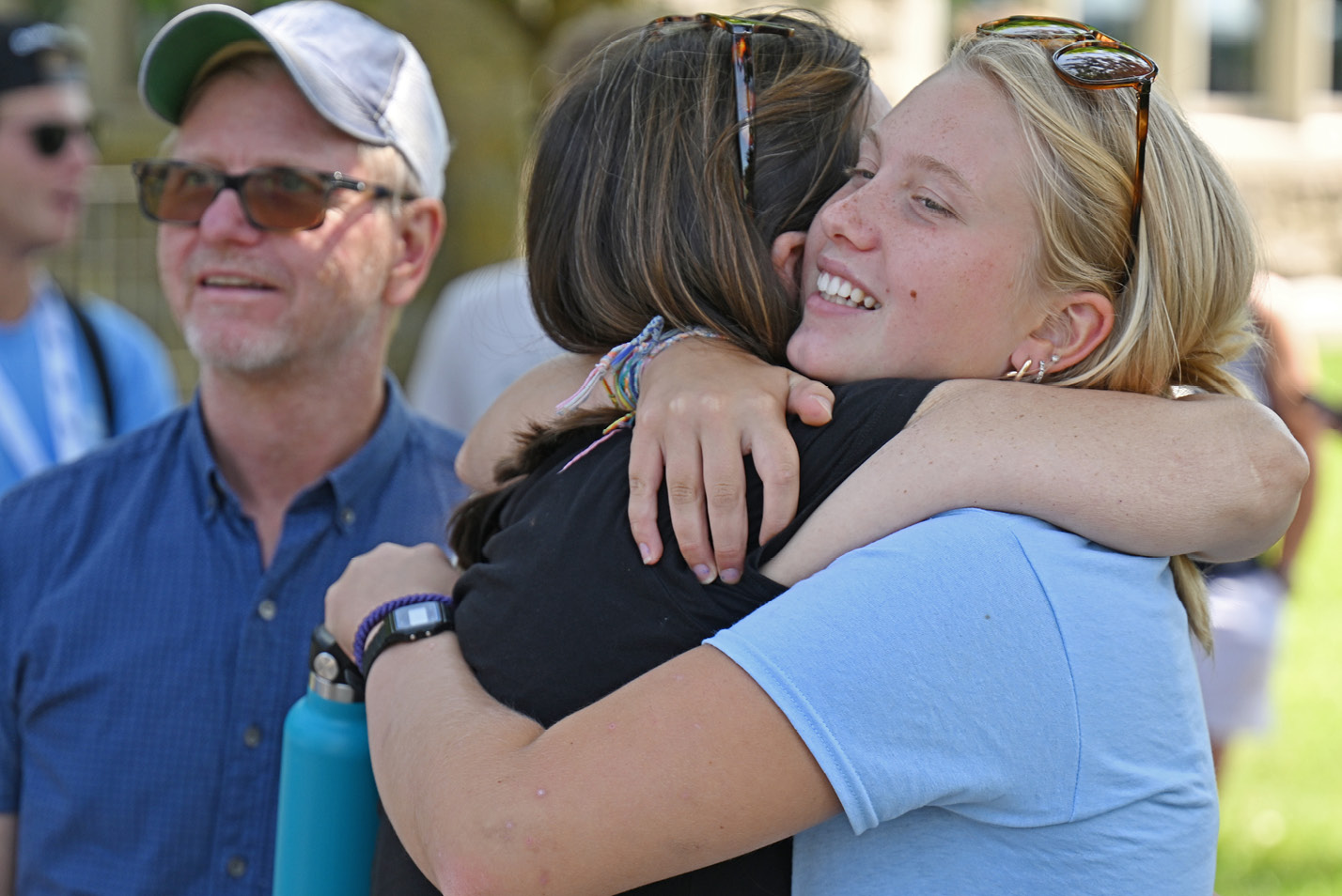 A student hugging a friend.