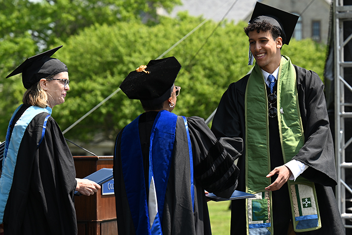 A student accepts their diploma