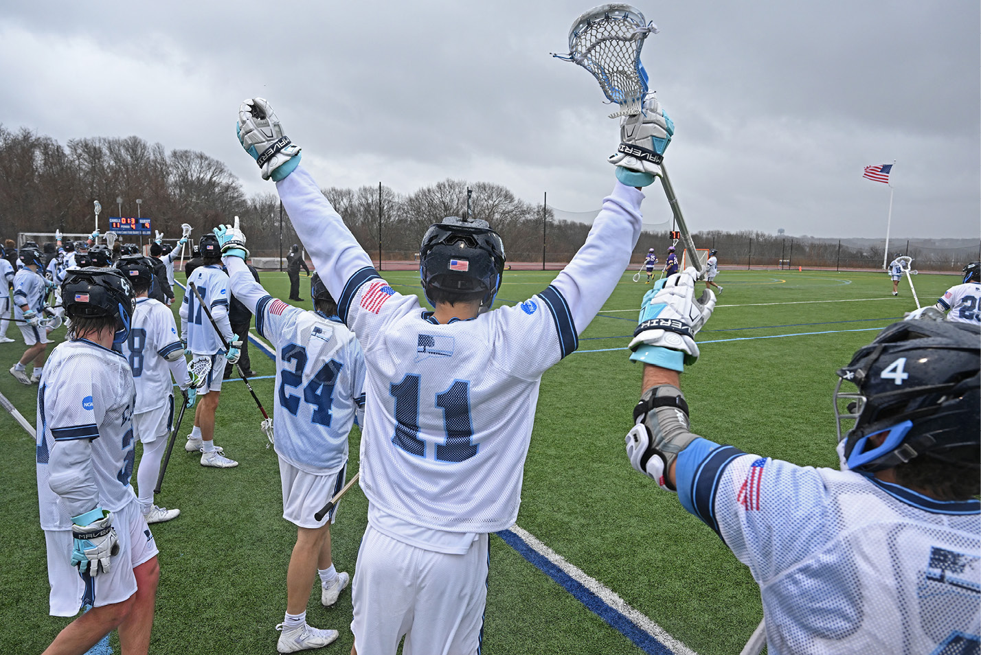 Connecticut College men’s lacrosse celebrates its 11-9 win over Williams College.