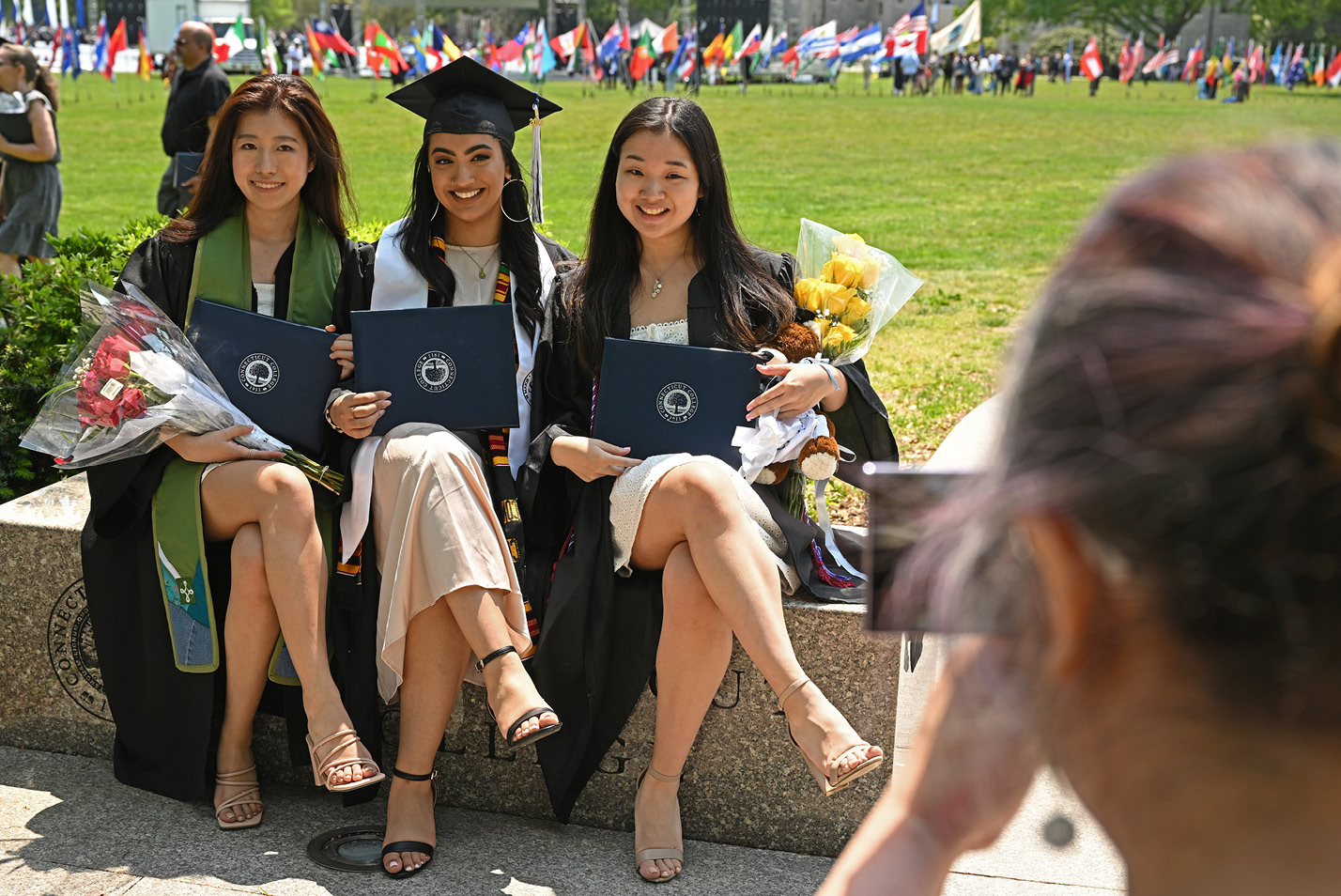 Students pose with their diplomas at Commencement 2023