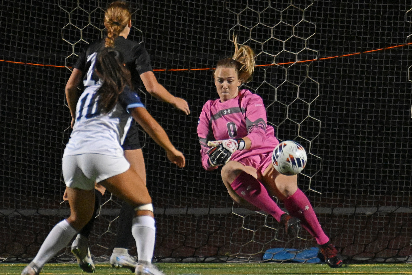 Women's soccer goalie makes a diving save