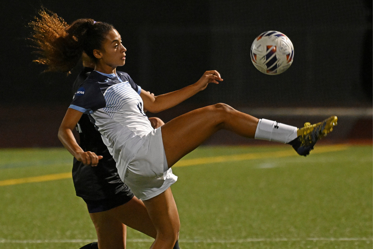 Women's soccer player makes a kick