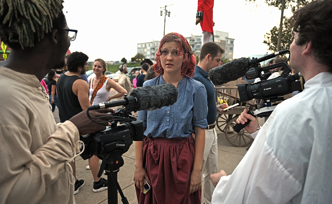 Filmmakers Timothy Friend ’25 and Ian Hopkins ’25 interview Jo Duckett ’25 at the 2023 Flock Theatre Burning of Benedict Arnold Festival.