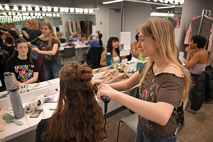 actor gets hair styled backstage