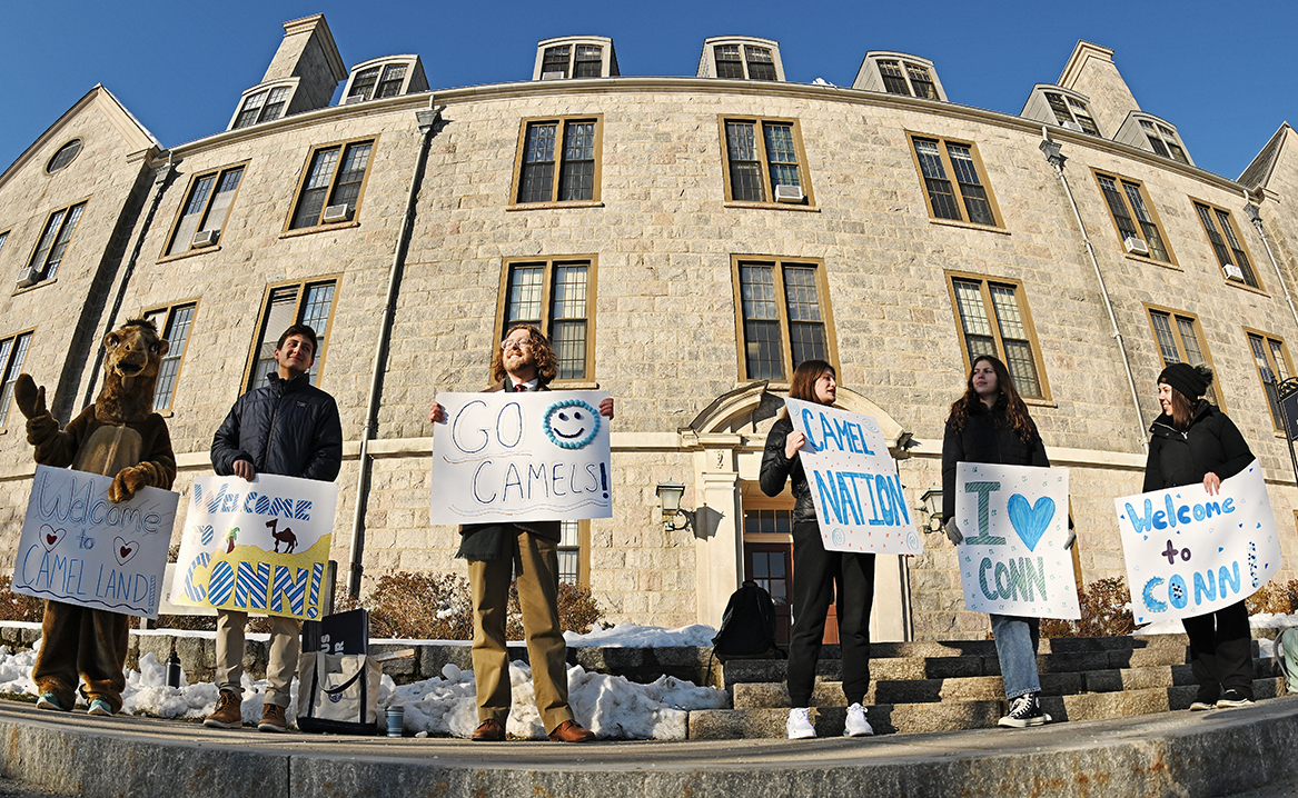 A row of students holding signs