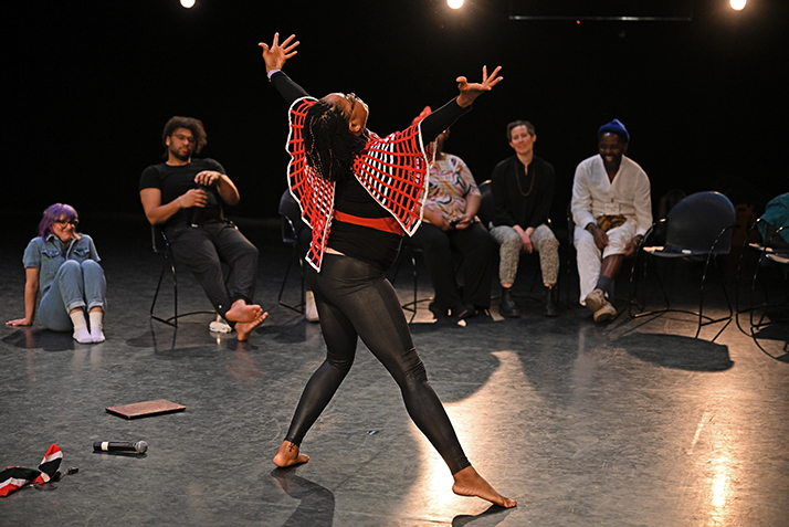 Dancer strikes pose in front of audience