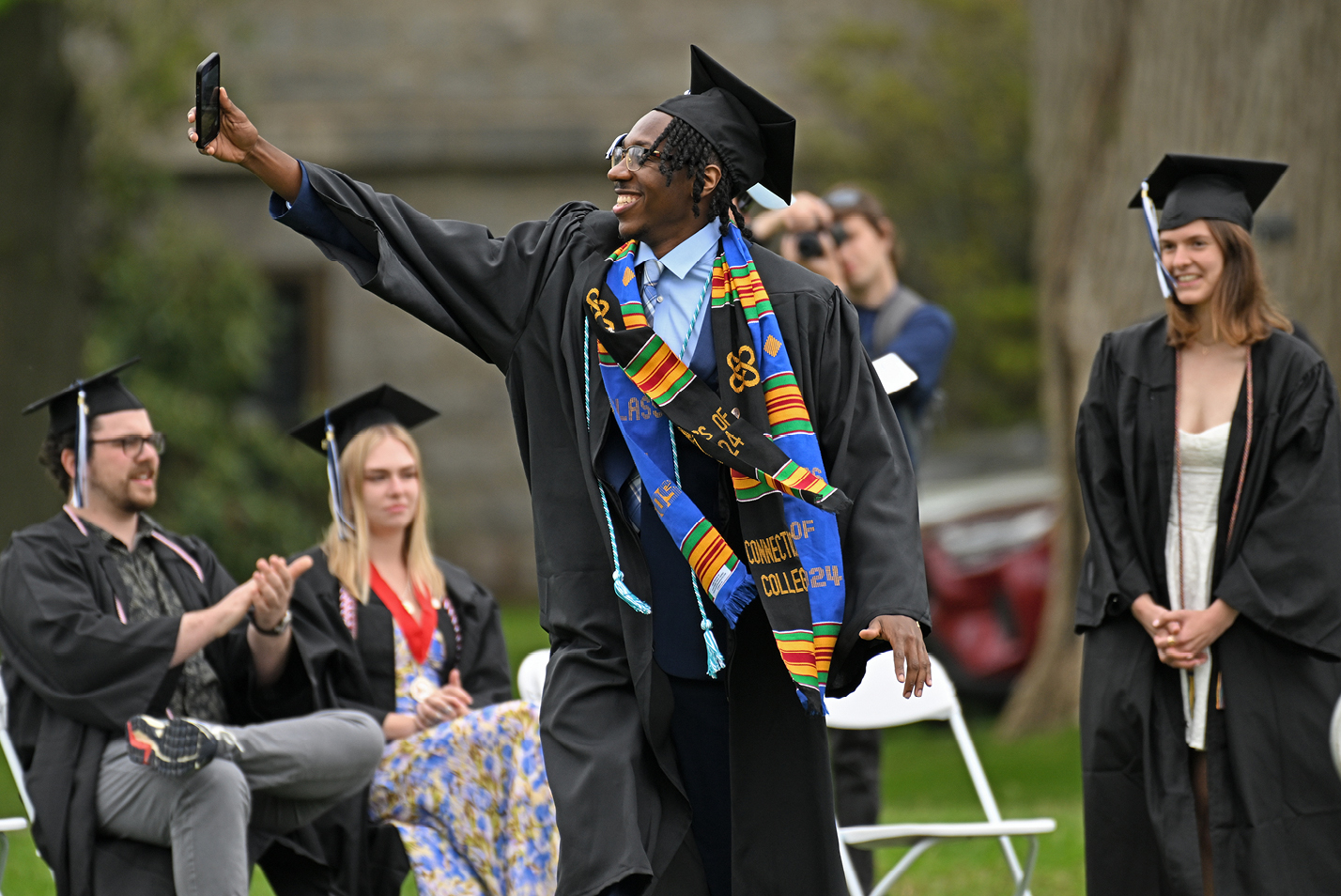 A student takes a selfie during Commencement.