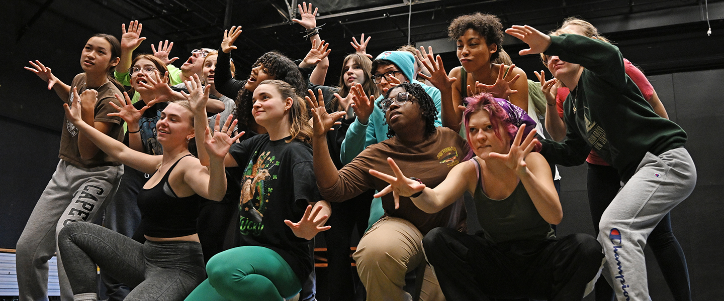 The cast of Urinetown rehearses.