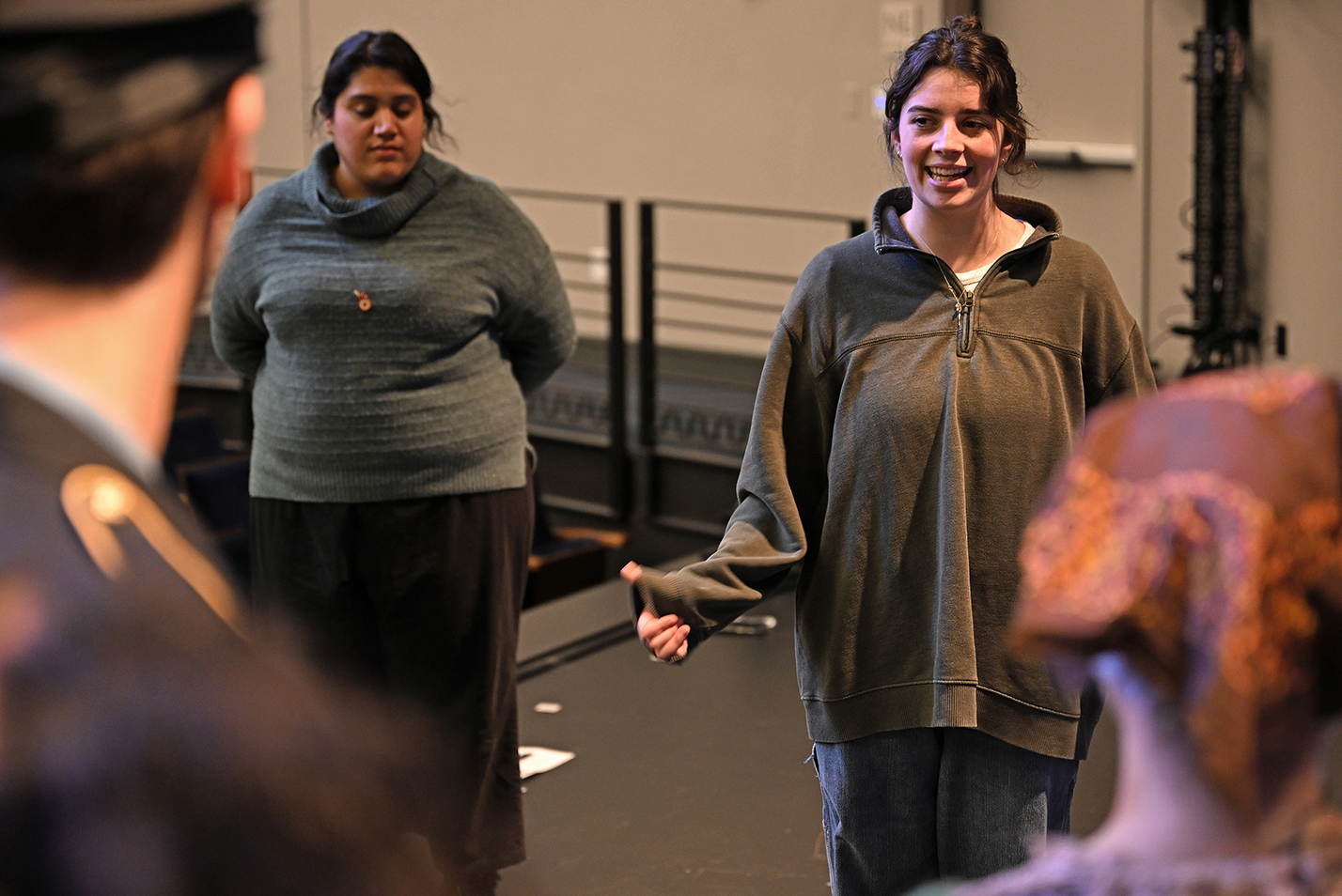 director and stage manager speak to cast on stage