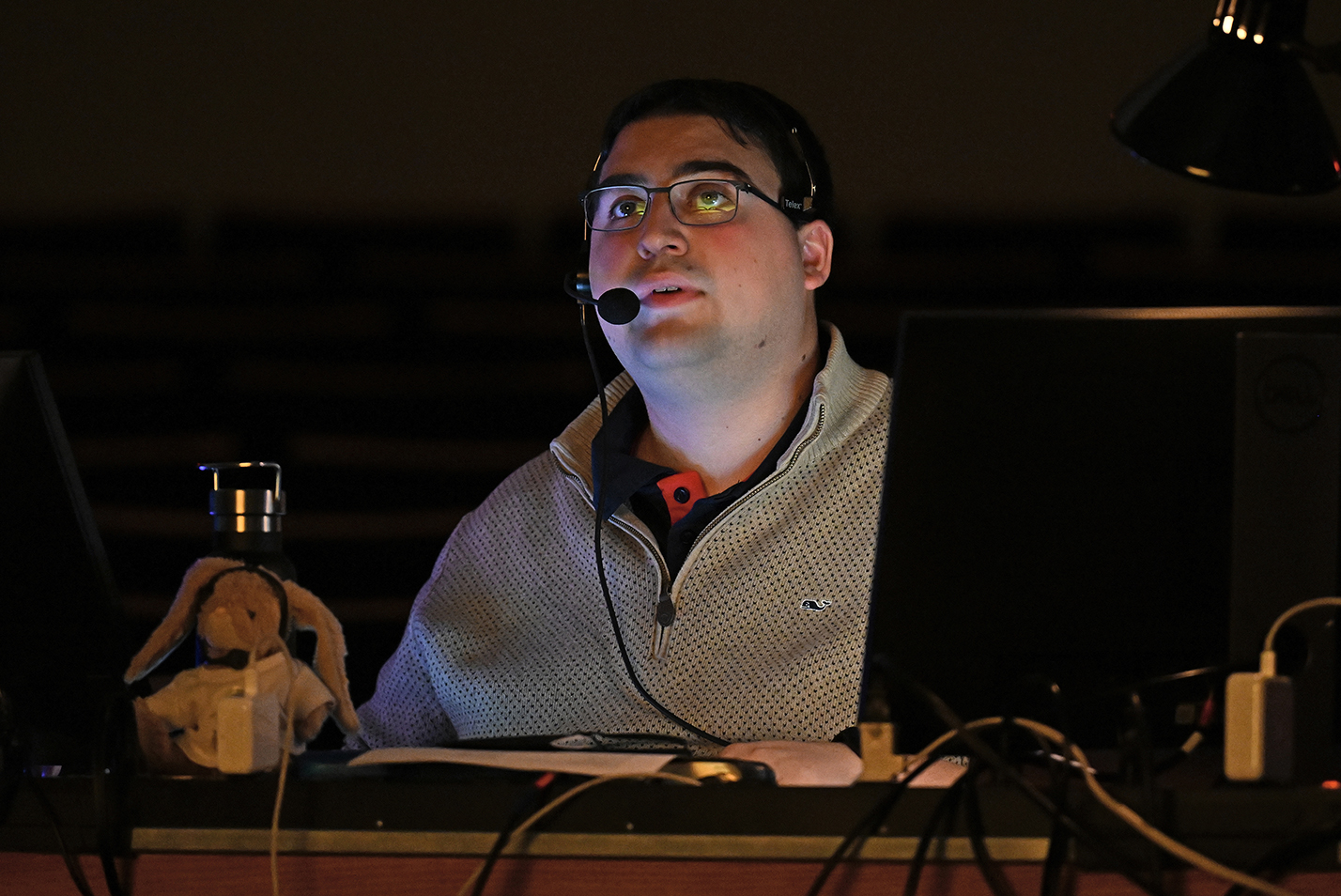 man sitting at computer in dark