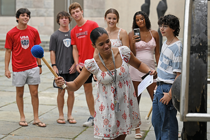 A new students rings the gong.