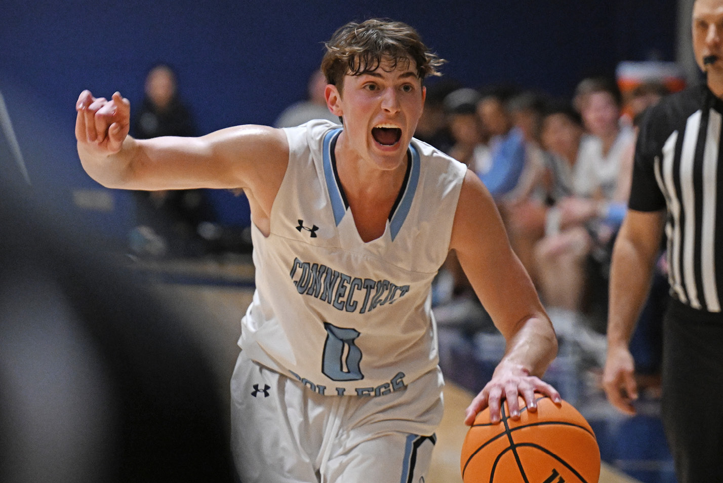 Connecticut College men's basketball guard Cam Schainfeld '25 dribbling vs. Wesleyan