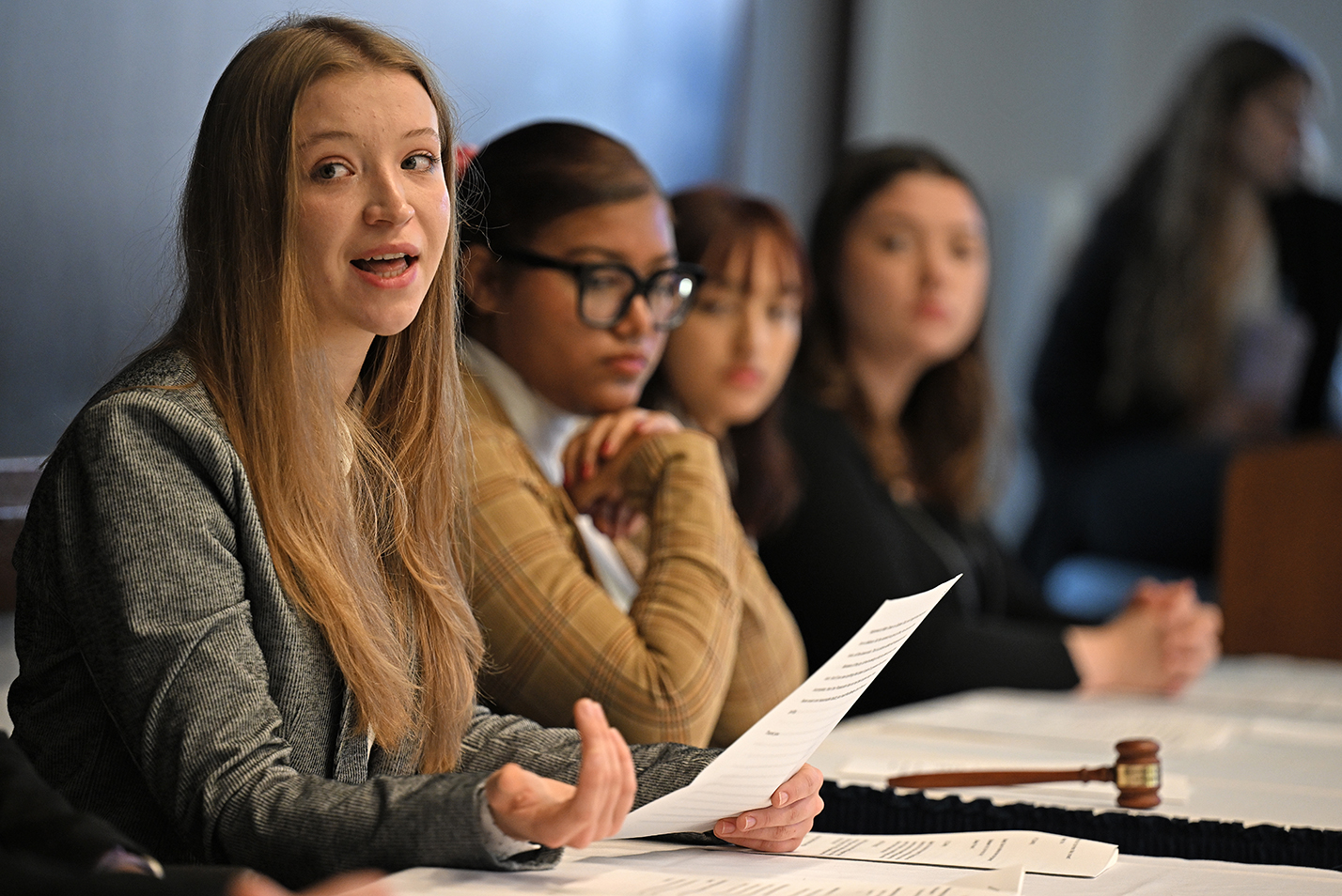 A student in the role of defense counsel makes a point during a mock trial demonstration.