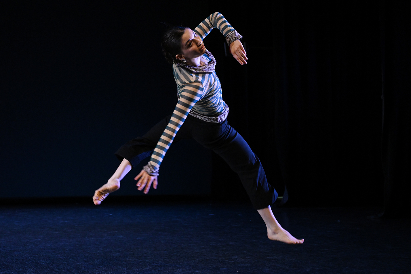 A dancer leaps through the air